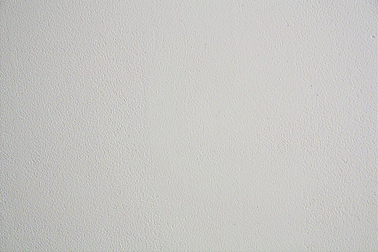 Close-up of a textured white wall, ideal for backgrounds in design projects.